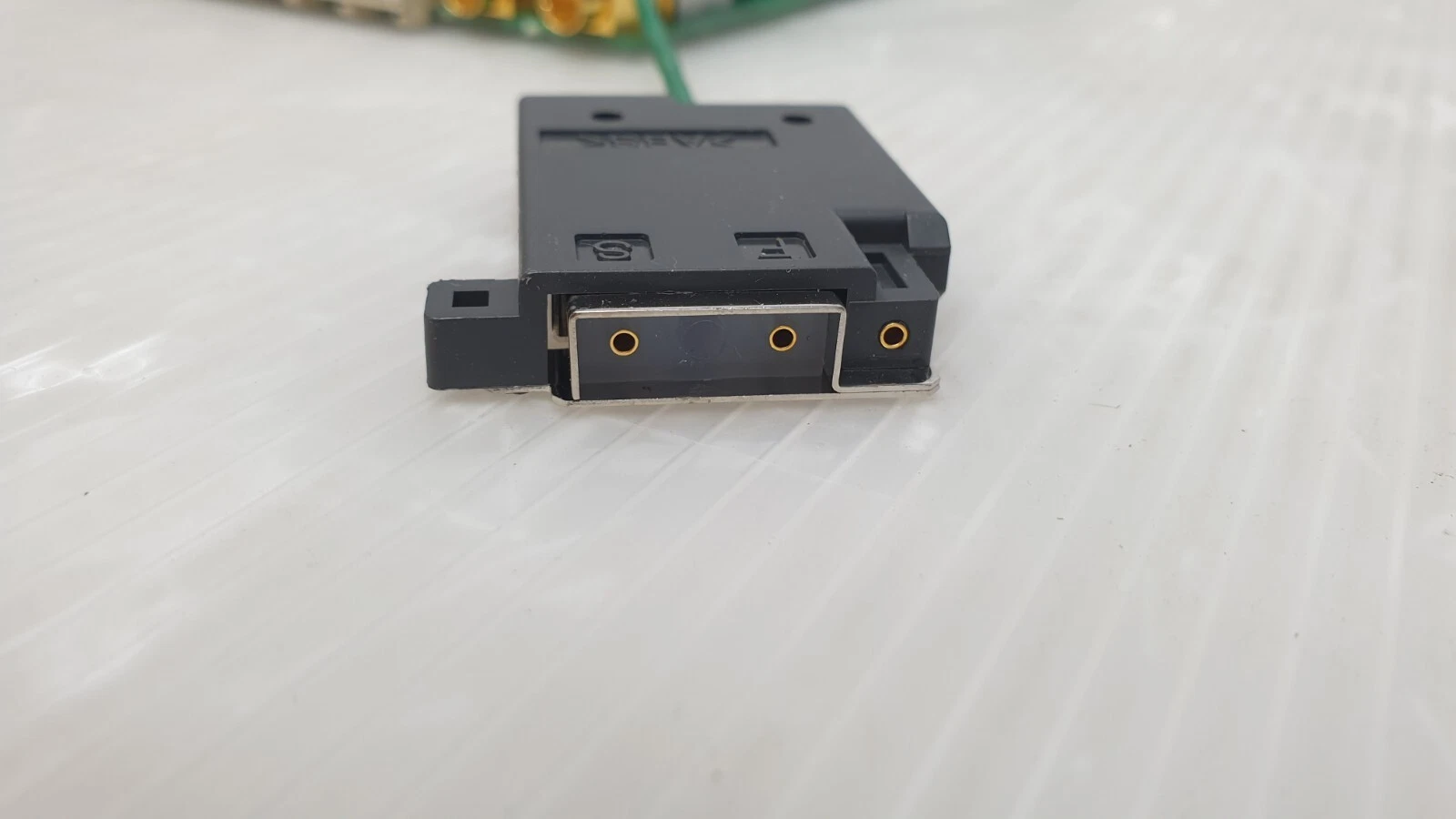 Face of the black connector block showing gold socket contacts