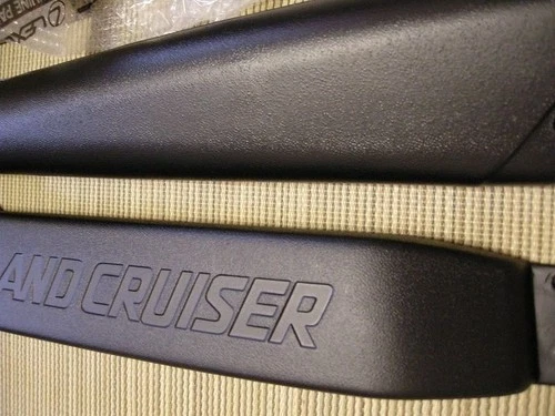 Black Toyota 70 Series Land Cruiser air intake snorkel set with textured black straps and white “LAND CRUISE” lettering on side.