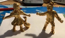 Gold-colored lad with goose girl