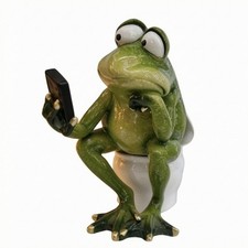 Froschfigur auf Toilette gl&auml;nzende Oberfl&auml;che Frosch auf WC gr&uuml;n