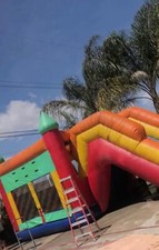 jumper bounce house with slide. multi color.