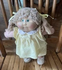 Vintage Cabbage Patch Kids doll with blonde/wheat colored pigtails & blue eyes.