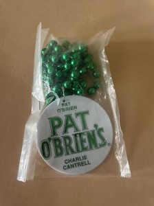 PAT O’BRIEN’S Plastic Charm/Pendant (2 1/2” Across) on Green Mardi Grad Beads
