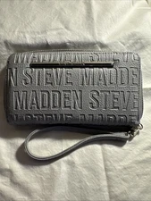 Steve Madden wallet or wristlet in a grey leather material withlogo pattern.