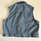 Vintage blue cotton denim vest XL with button front, pointed collar, and flap pockets, made in USA.