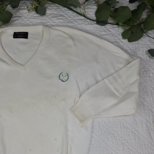 White V-neck Christian Dior men’s sweater with small green embroidered logo and stars on chest, made in USA.