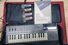 Casio Vintage PT-87 Mini Keyboard w/ ROM Packs, Soft Bag, Books, and Power Brick