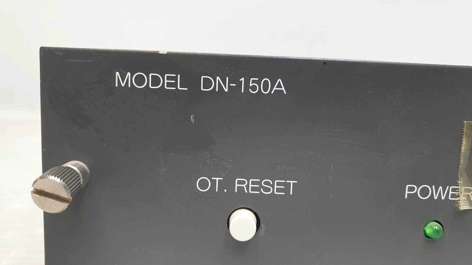 Close-up of the MODEL DN-150A marking and OT. RESET button