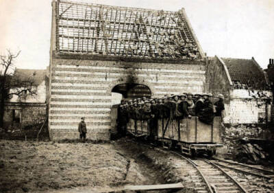 British troops on a train which runs through a damaged house Old Photo