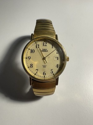 Timex Indiglo Carriage Black Dial Stretch Band Gold Tone