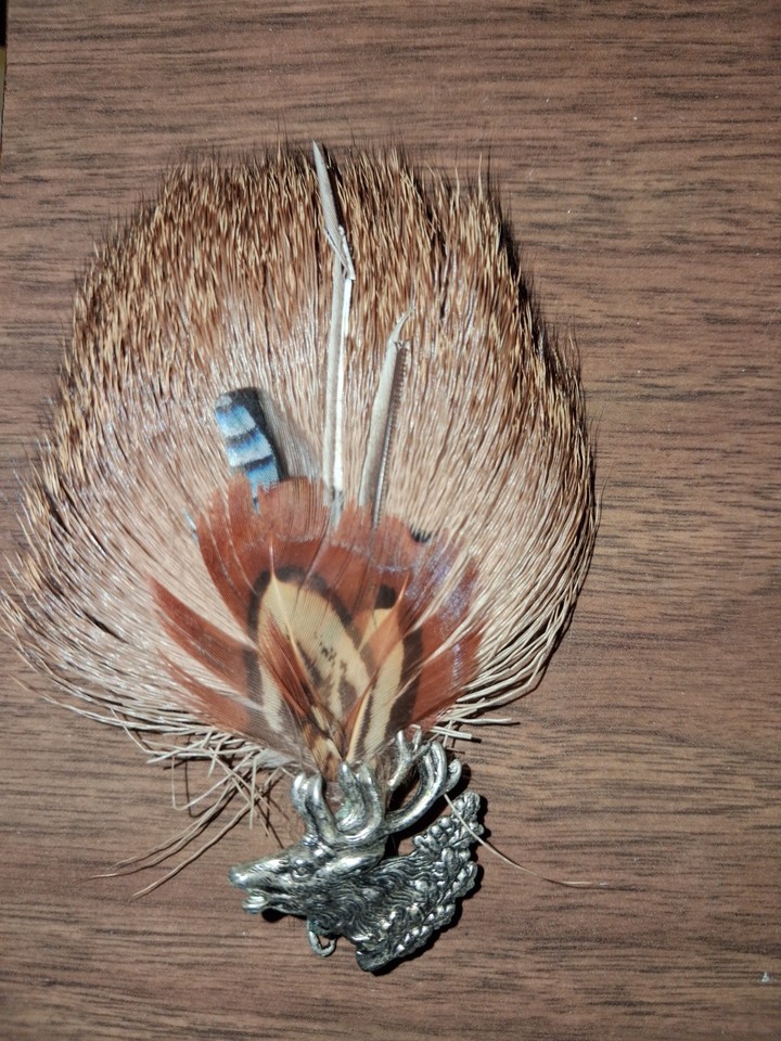 A vintage German hunting hat pin with a silver stag, real feathers, and fur — the kind of one-of-a-kind alpine artifact that looks like it came off a Bavarian count's hat.