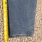 Blue high-waisted L.L.Bean mom jeans with visible yellow measuring tape across the waistband, size 12 32.