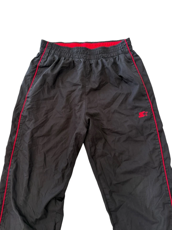 Pantalones cortavientos deportivos Starter negros para niños talla mediana 8 22x22 buen estado Foto 2 de 4