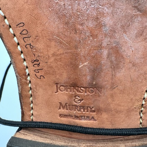 Brown leather Johnston & Murphy Optima Burgundy size 11 with black laces, stitched in place, on a dark background.