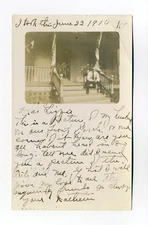 Hillsdale MI cancel, man, "our front porch", furled flags, 1910 RPPC postcard