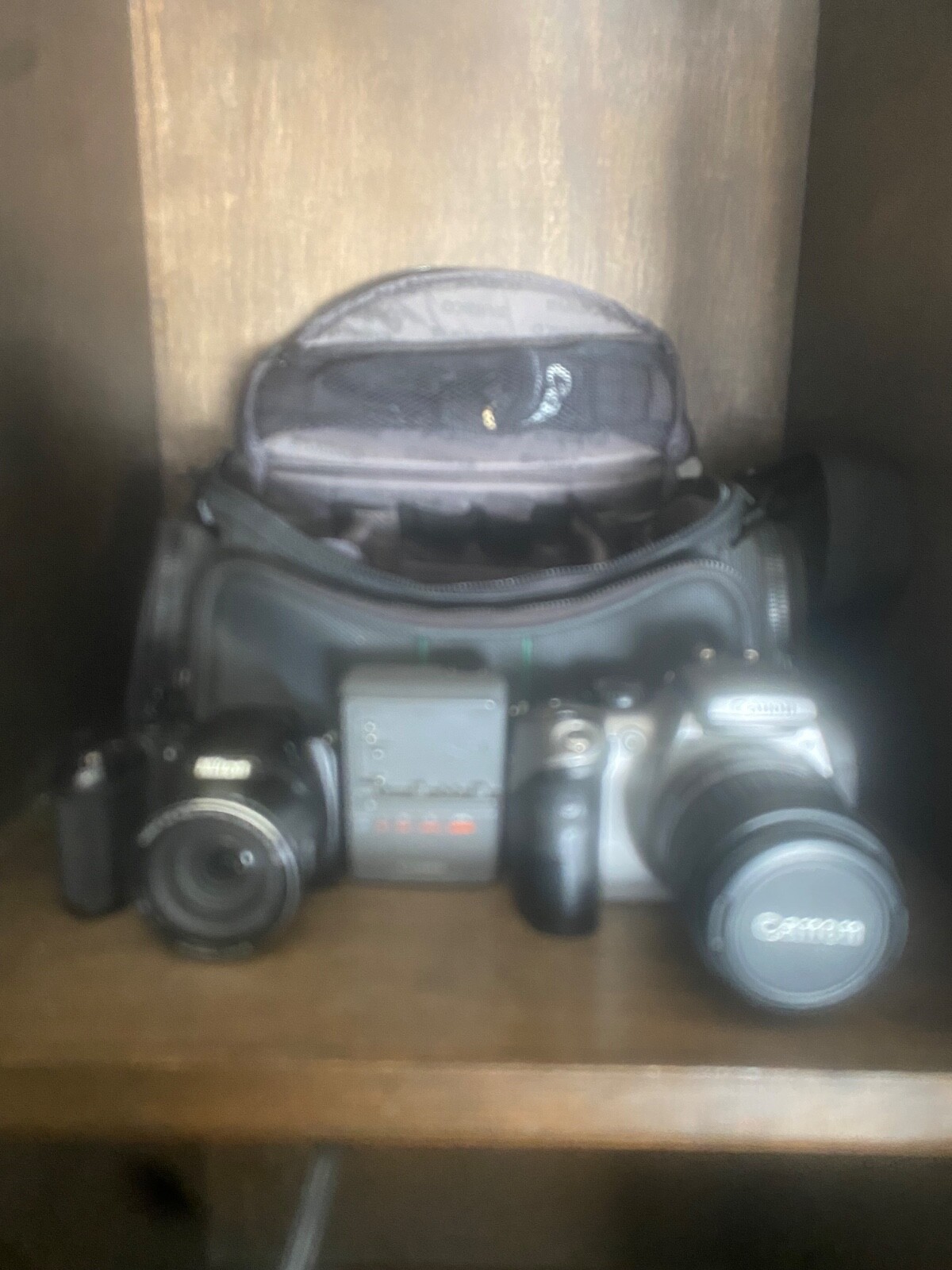 Canon DS6041 with charger & Nikon CoolPix L330 Cameras. Comes in carrying bag