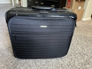 RIMOWA Business Trolley in black polycarbonate with front organizer compartment.