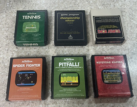 ATARI 2600 console with 25 games , 2 controllers and cords