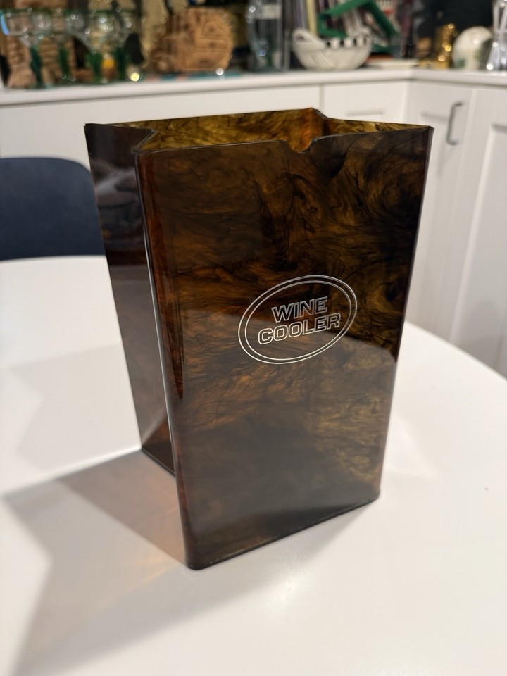 A 1979 tortoiseshell acrylic wine cooler shaped like a paper bag — Ted Arnold's quirky design is instantly recognizable to mid-century collectors and wildly fun for anyone else.