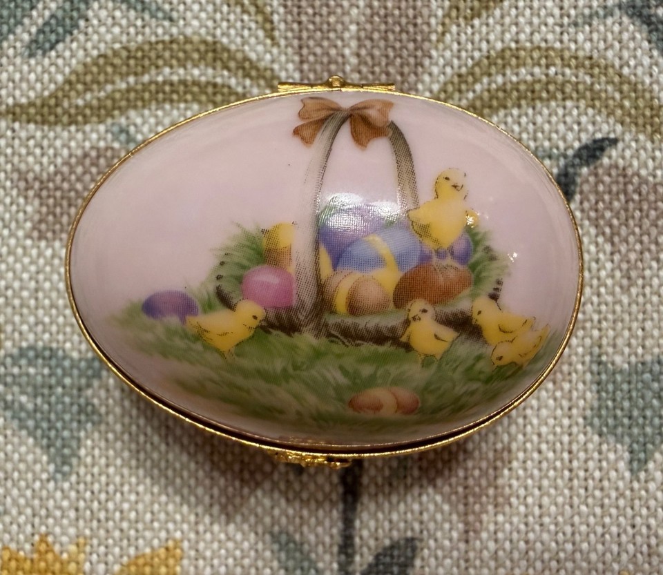 Hand-painted Limoges porcelain hinged egg with chick and basket scene — the kind of tiny treasure that makes antique lovers gasp.