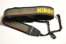 Nikon gray 1 1/2" wide cloth camera strap.