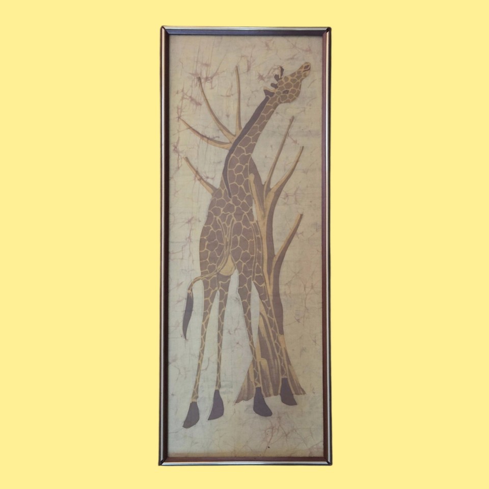 Hand-crafted batik giraffe art in a vintage frame bridges safari, boho, and MCM — a genuinely one-of-a-kind textile wall piece.