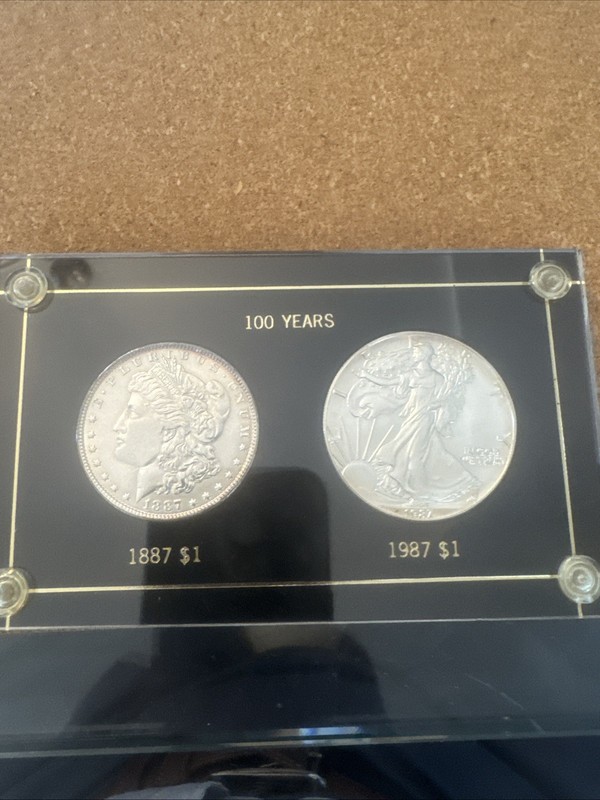 1887 Morgan Dollar and 1987 Silver Eagle In An Acrylic Case - UNC Condition