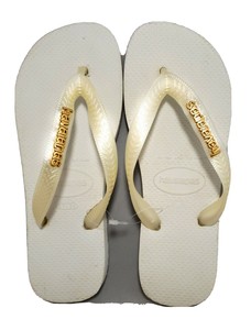 white and gold flip flops