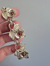 Vintage silvertone floral bracelet with red rhinestones