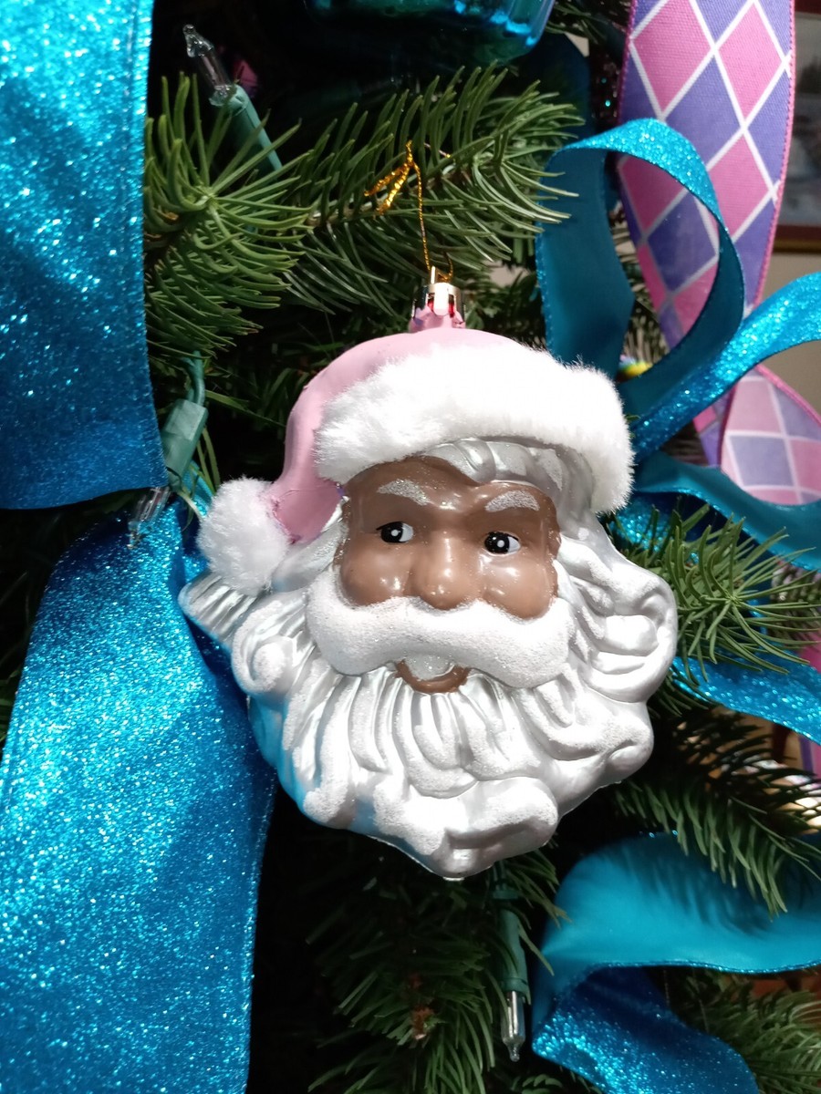 black santa dressed in pink honey brown melanin African American women, with long black and blonde flowing hair, wearing a pink Santa hat, pink and sliver high boots, pink Santa dress that say standing outside in the