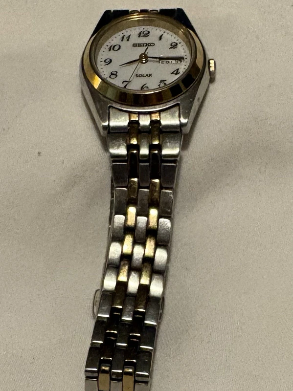Seiko solar women's quartz analog watch with day and date on a two-tone bracelet