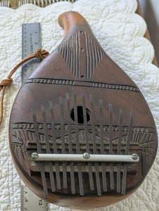 Kalimba, (thumb piano) handmade of gourd and wood, tuned percussion. Metal keys