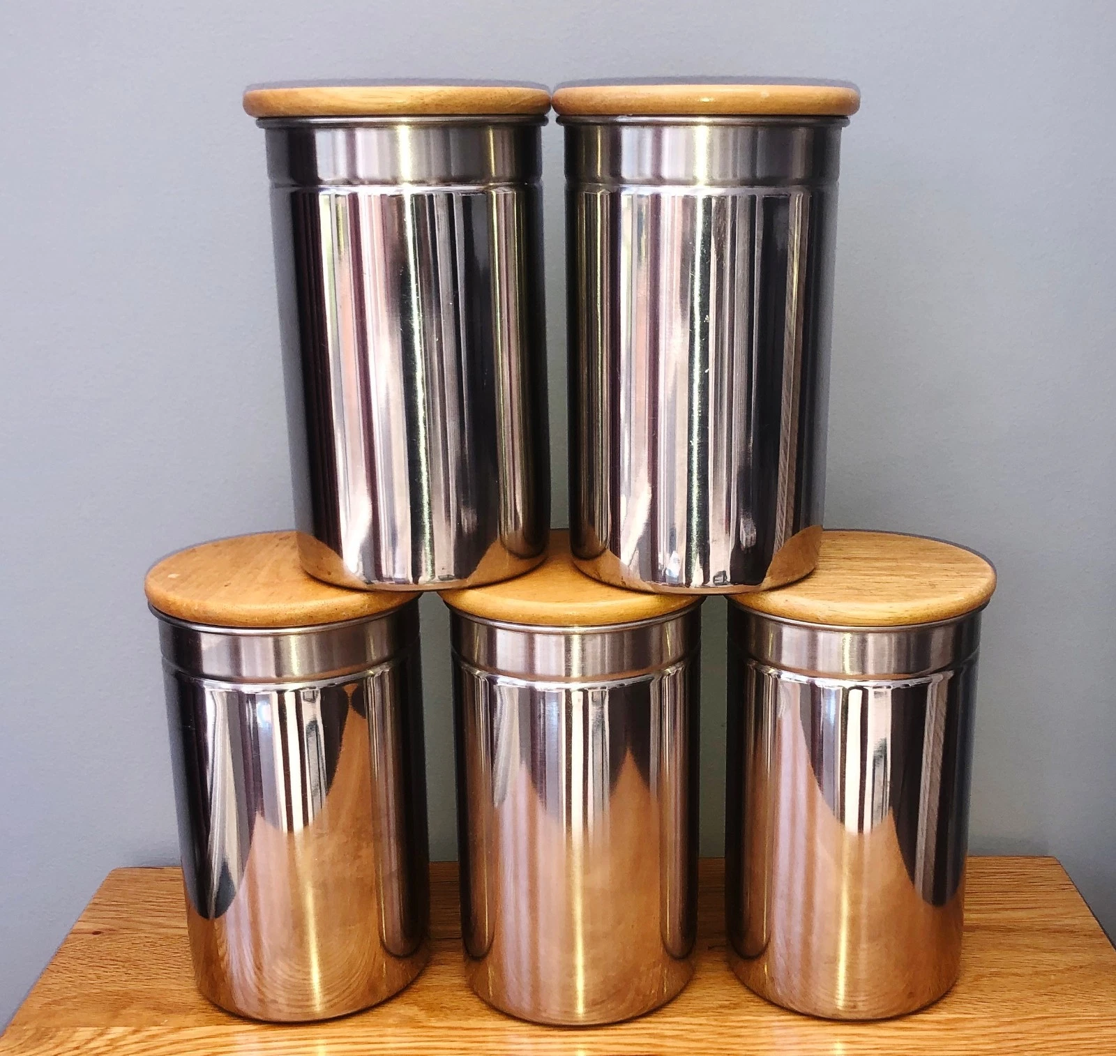 Set Of 5 Stainless Steel Storage Jars With Wooden Lids.