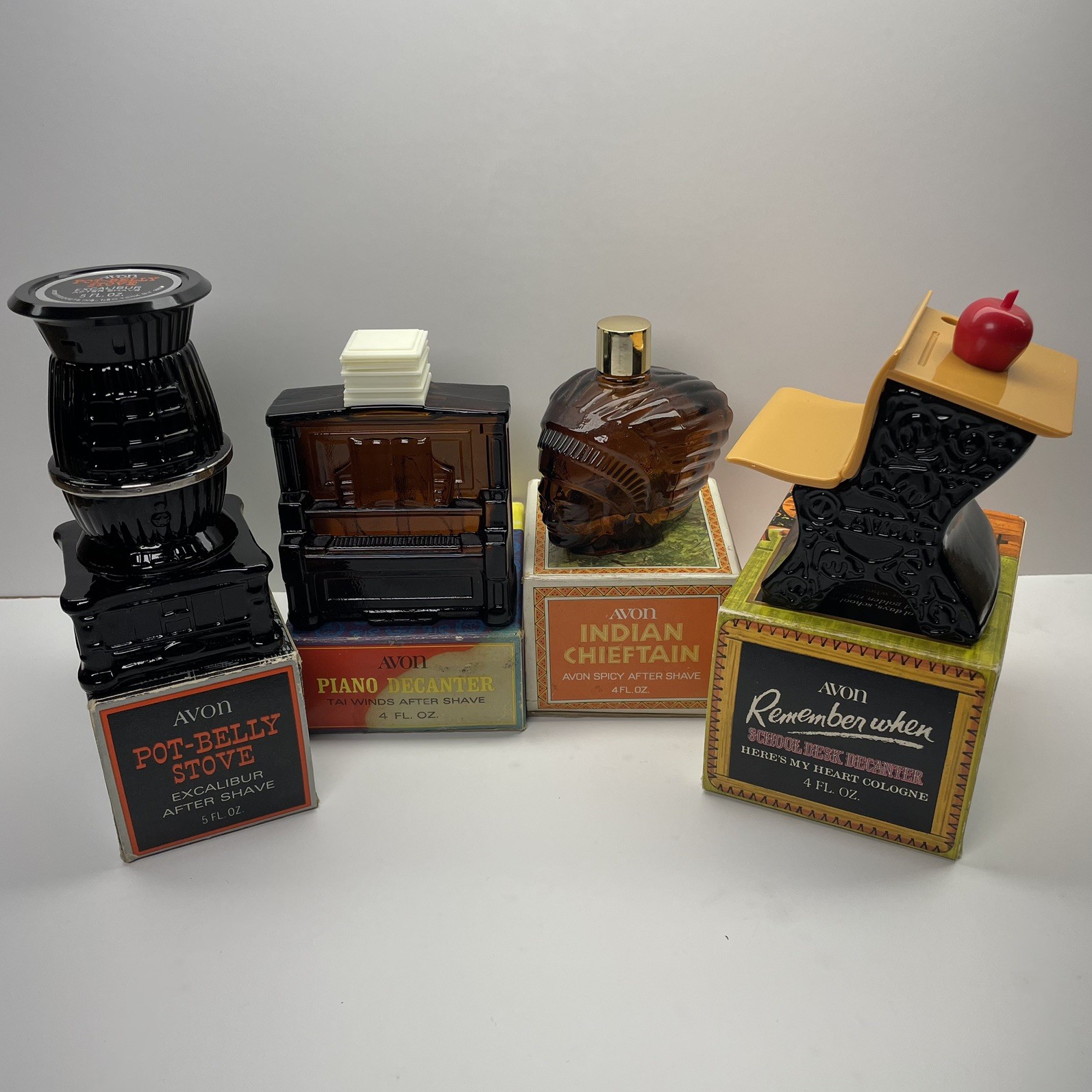 Lot of 4 Vintage Avon Decanter Bottles Piano Desk Stove Indian Chief - W/ Boxes