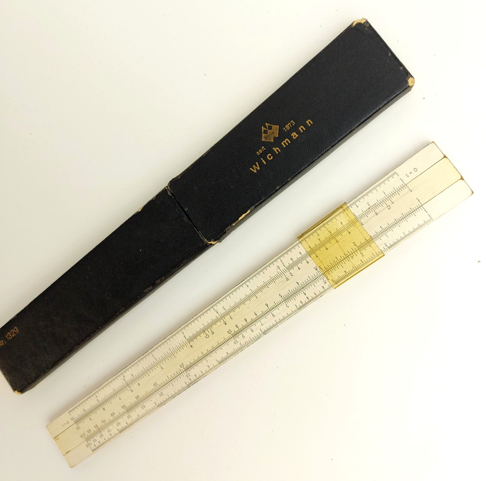 A Wichmann/Albert Nestler wooden slide rule — a beautifully crafted pre-calculator computing instrument that's both a working relic and a display-worthy object.