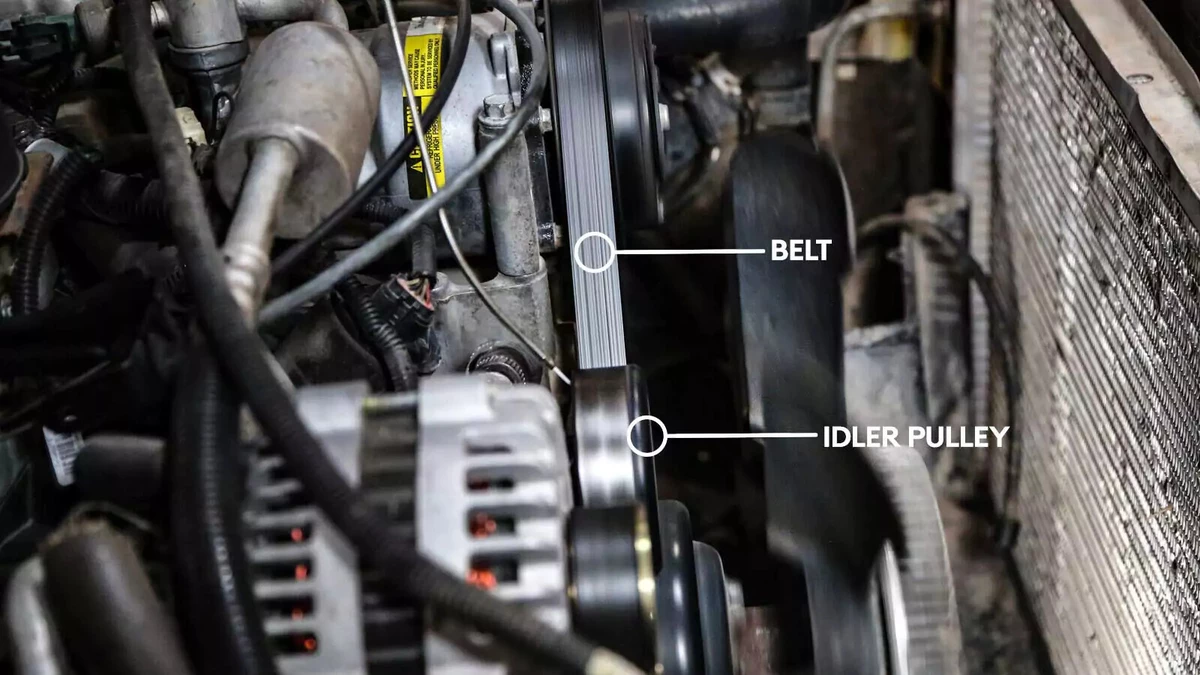 This idler pulley is positioned above the water pump and next to the alternator.