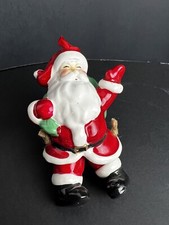Santa Claus Carrying Bag With Dangling Legs Ceramic Christmas Ornament