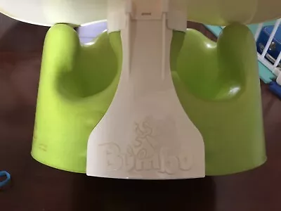 green bumbo with tray