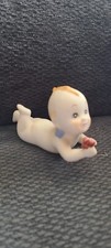 Kewpie Holding A Rattle
