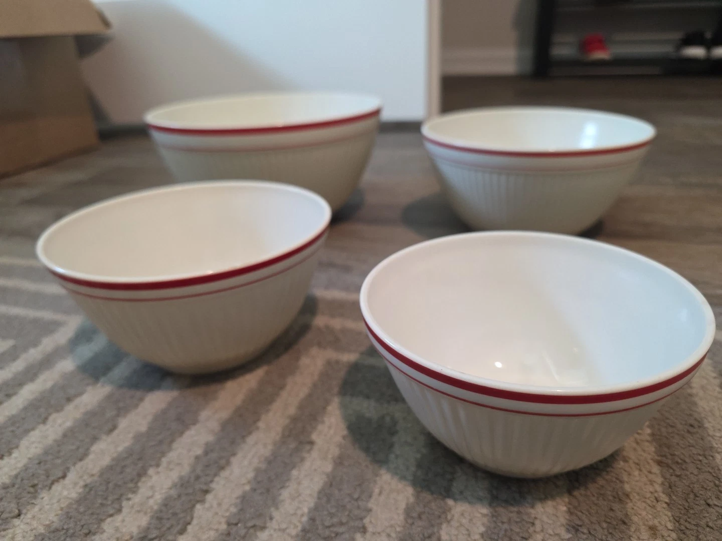 Vintage white ribbed glass mixing bowls with a red stripe rim