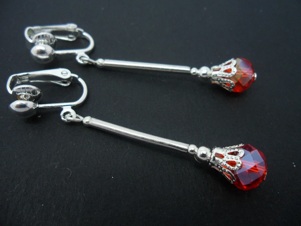 A PAIR OF DANGLY RED CRYSTAL BEAD SILVER PLATED CLIP ON EARRINGS. - Image 1 of 1