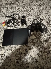 PlayStation 2 slim console with cords and controller