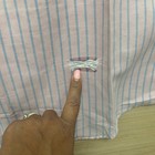 Light pink LL Bean short sleeve oxford shirt with vertical blue stripes and a small red square fabric patch on the front.