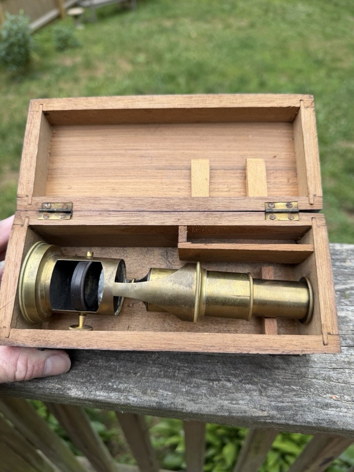 A tiny antique brass drum microscope that fits in your pocket — a working piece of 19th-century field science straight out of a Victorian naturalist's kit.