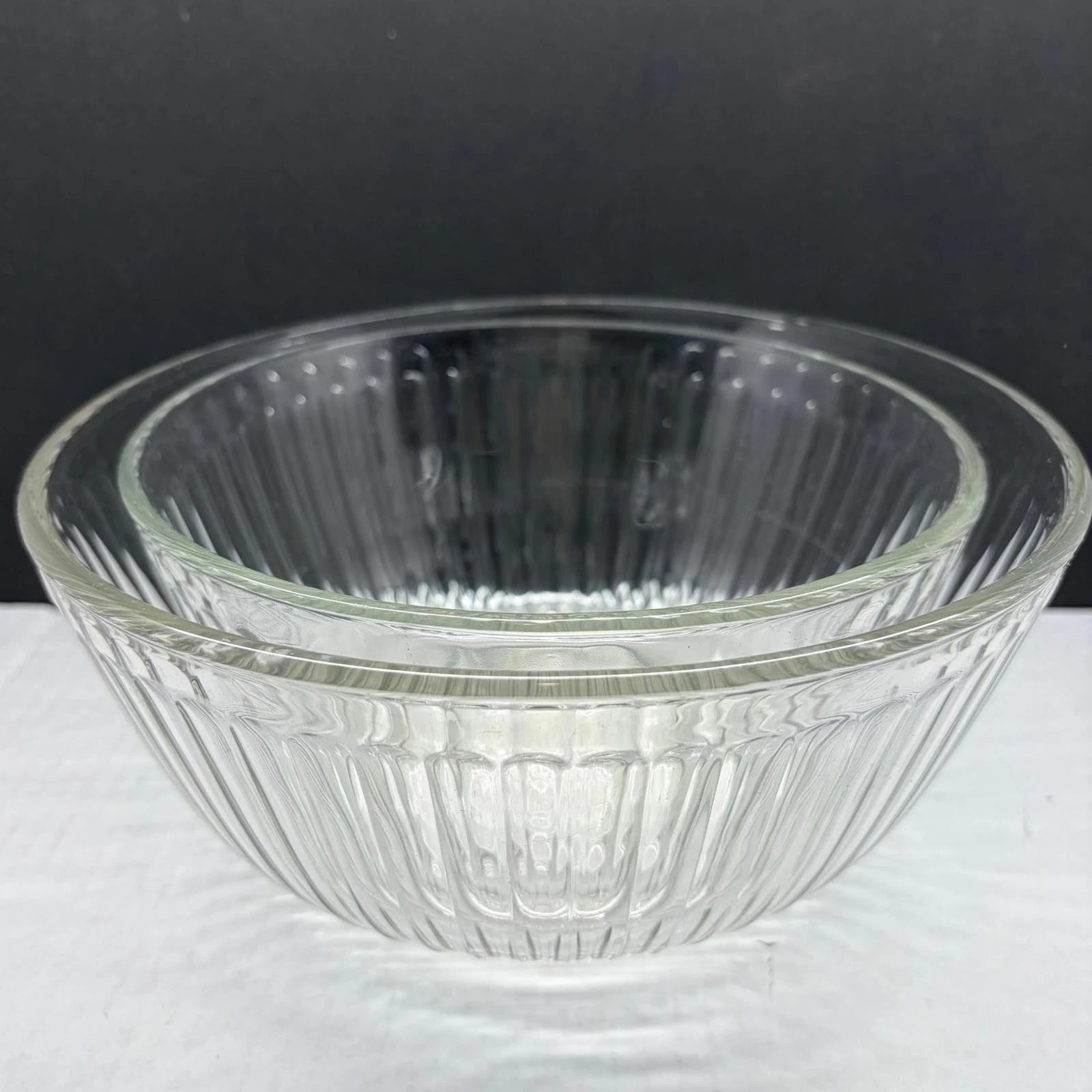 Vintage 7-inch diameter clear glass Pyrex ribbed mixing bowl.
