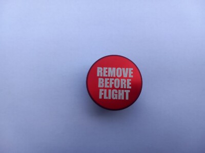 NOVELTY REMOVE BEFORE FLIGHT BUTTON PLUG 12v UNIVERSAL CIGARETTE LIGHTER COVER