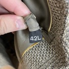 Close-up of Haggar men's sport coat with black size 42L tag, two-button front, and beige textured plaid fabric.