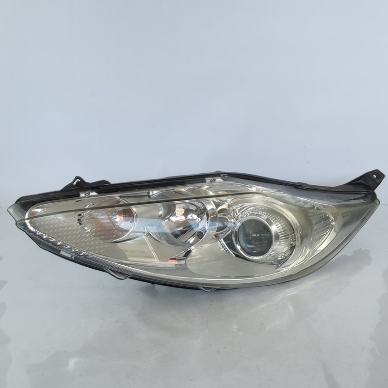 1740028 Proiettore SX FORD FIESTA (CB1) 1.6 16V (88Kw) Ber. 3p/b/1596cc