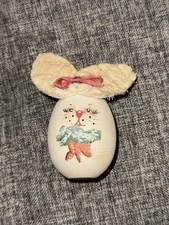 Decorative collectible egg designed to look like a bunny holding carrots