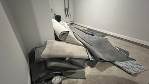 Used carpet pieces — recently replaced with wood tiles
